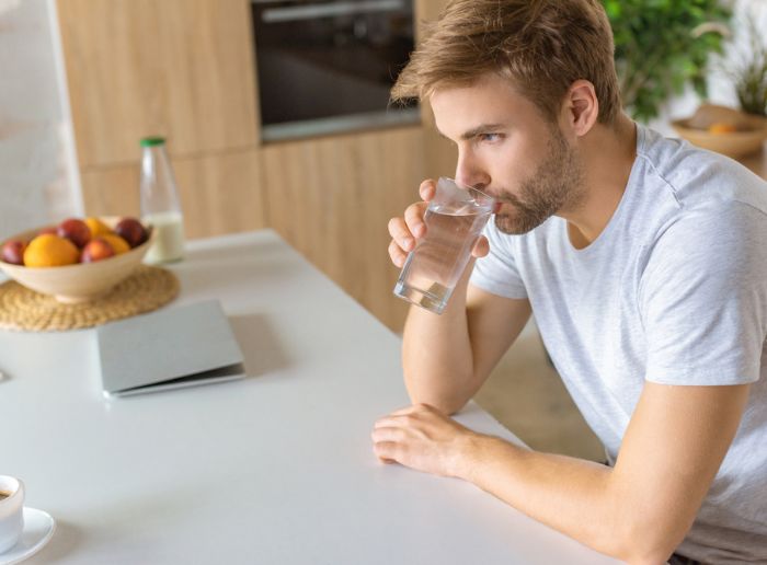 man from Durham, NC, drinking water from a home water filtration system
