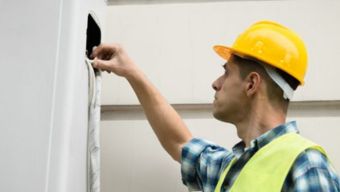 Technician performing an emergency ac repair in Raleigh, NC