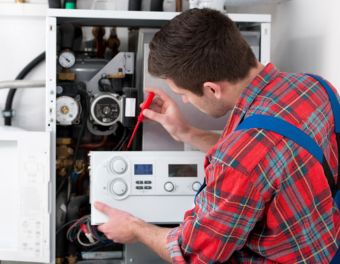 Technician Performing a Residential Heater Repair in Wake County, NC