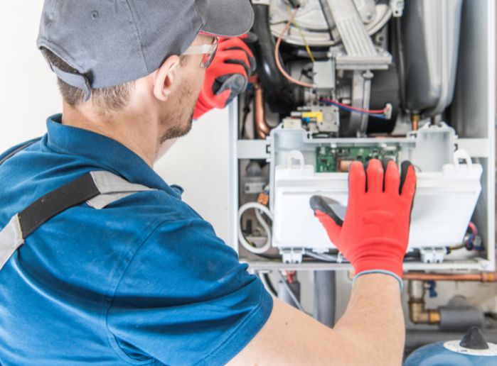 Technician Performing a furnace repair in Wake County, NC